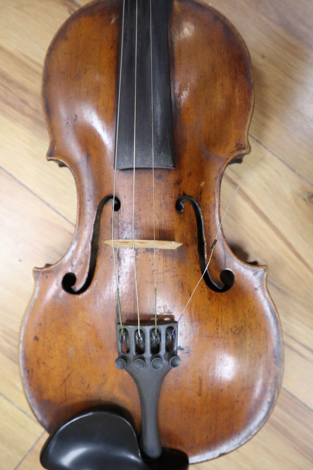 A cased violin with two bows. Violin bears the label Carl Willhelm Claesel, circa late 18th century/early 19th century, 35.5cm back in